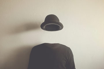shirt and bowler hat supported without a head