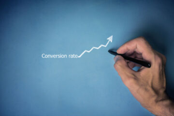 hand writing conversion rate with an upwards trending graph